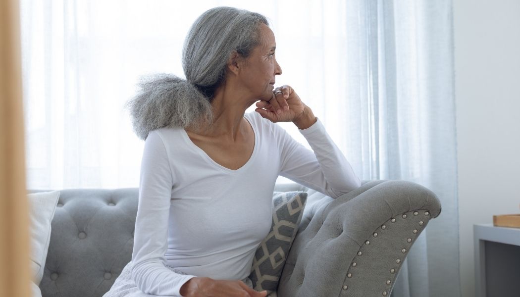 single woman sitting on couch