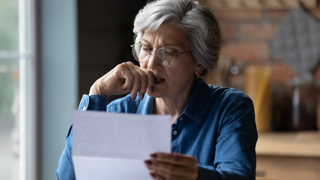 Mature woman reading paper
